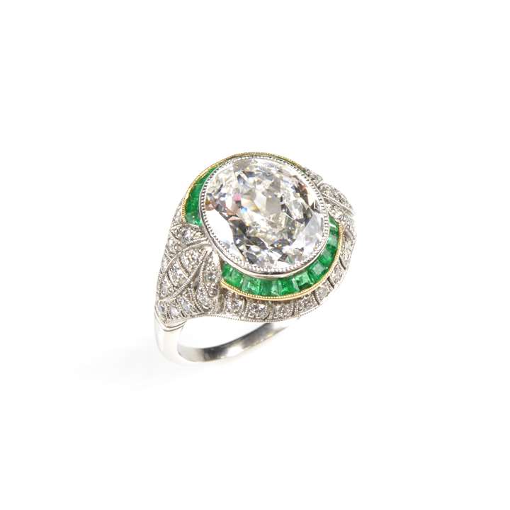 Oval diamond and emerald and diamond cluster ring